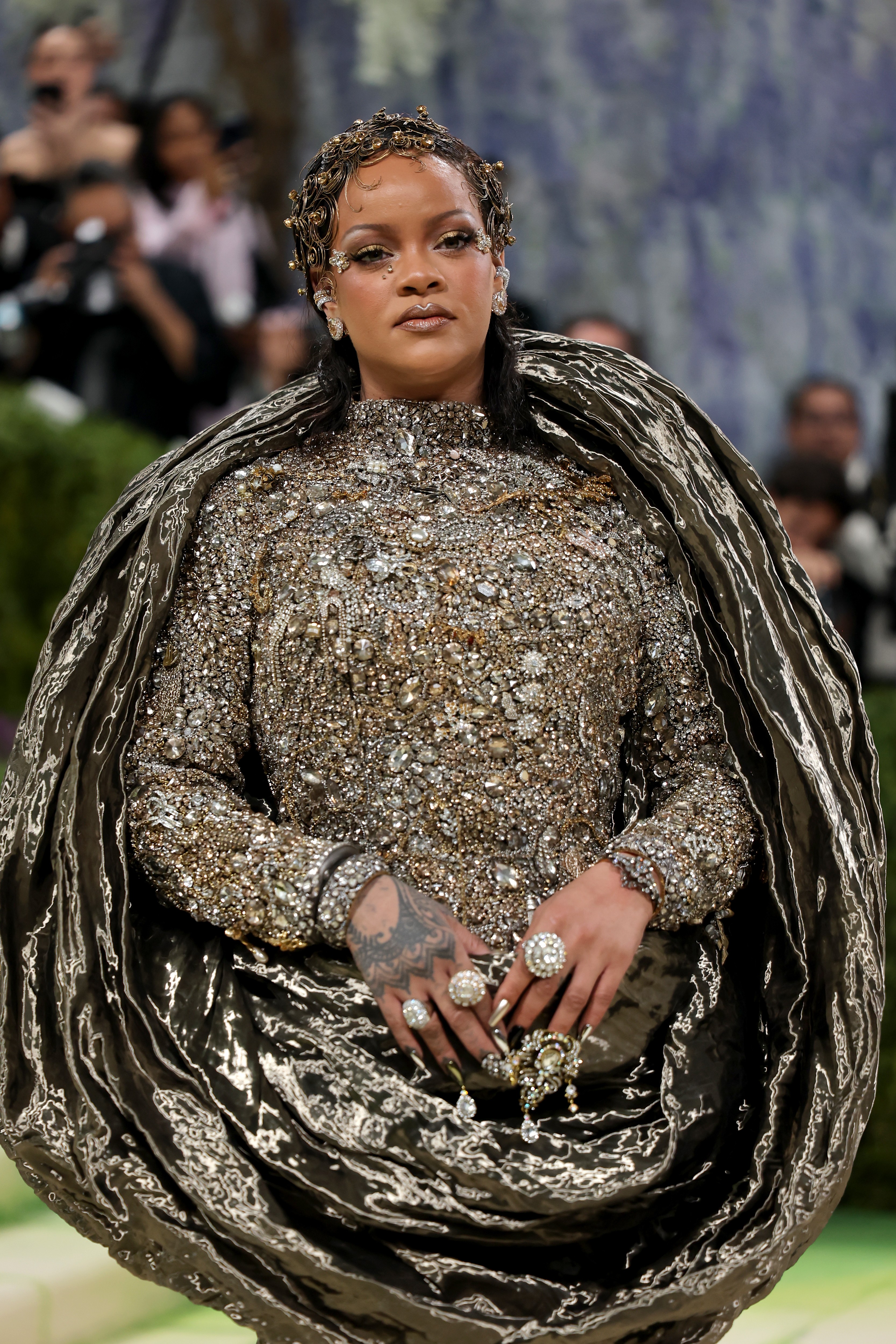 Rihanna surge no Met Gala 2026 com aplicações de cachos metálicos e pedraria