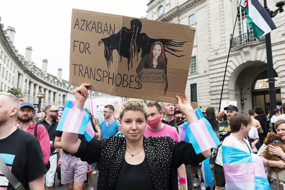 Um manifestante segura um cartaz contra a autora JK Rowling durante a sétima marcha de protesto do Orgulho Trans em Londres, em 26 de julho de 2025 — Foto: GettyImages